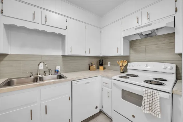 a kitchen with cabinets appliances a sink and a cabinets