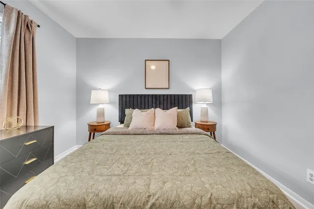 a bedroom with a bed and a dresser