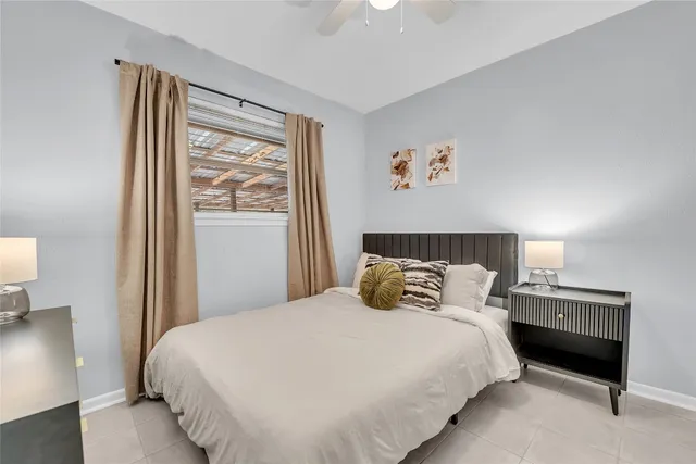 a bedroom with a bed and a night stand