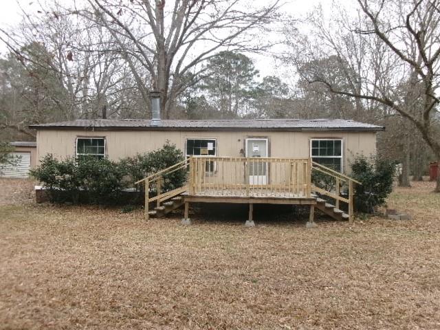 a view of a house with backyard and couches
