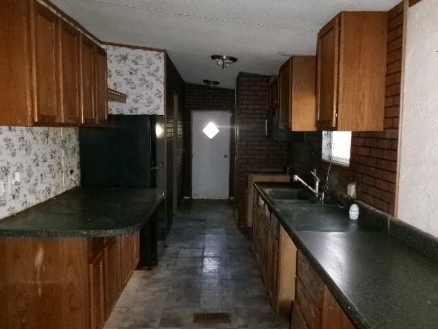 9603 Rosalie Loop Keithville, LA 71047 - Photo 11 of 14 a kitchen with stainless steel appliances granite countertop a sink a stove and a wooden cabinets