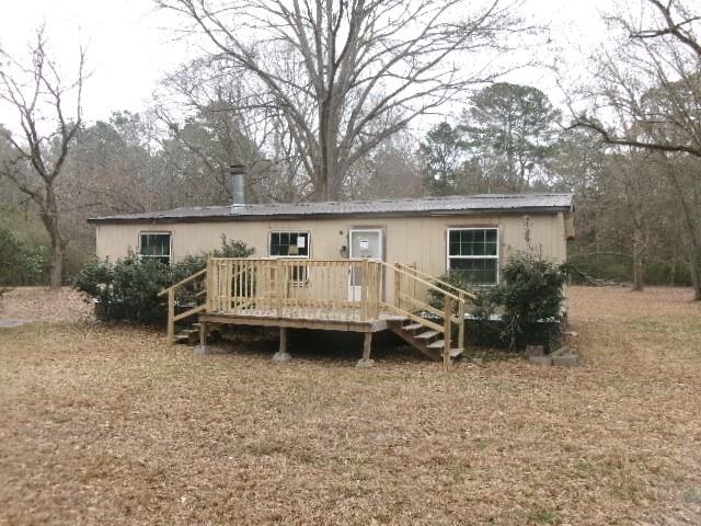 9603 Rosalie Loop Keithville, LA 71047 - Photo 2 of 14 a backyard of a house with table and chairs