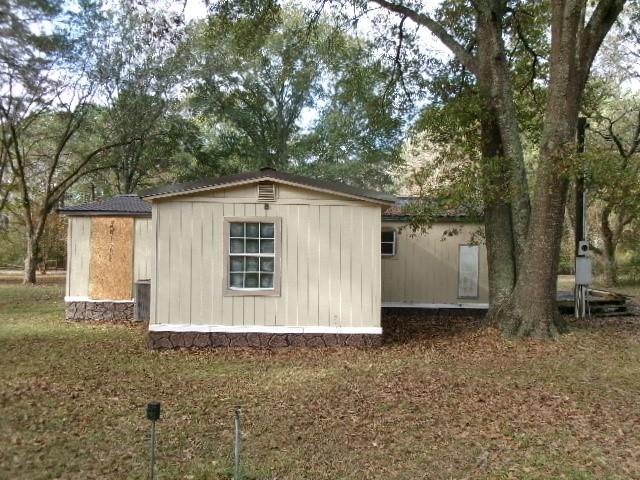 9603 Rosalie Loop Keithville, LA 71047 - Photo 5 of 14 a view of a house with a backyard and trees