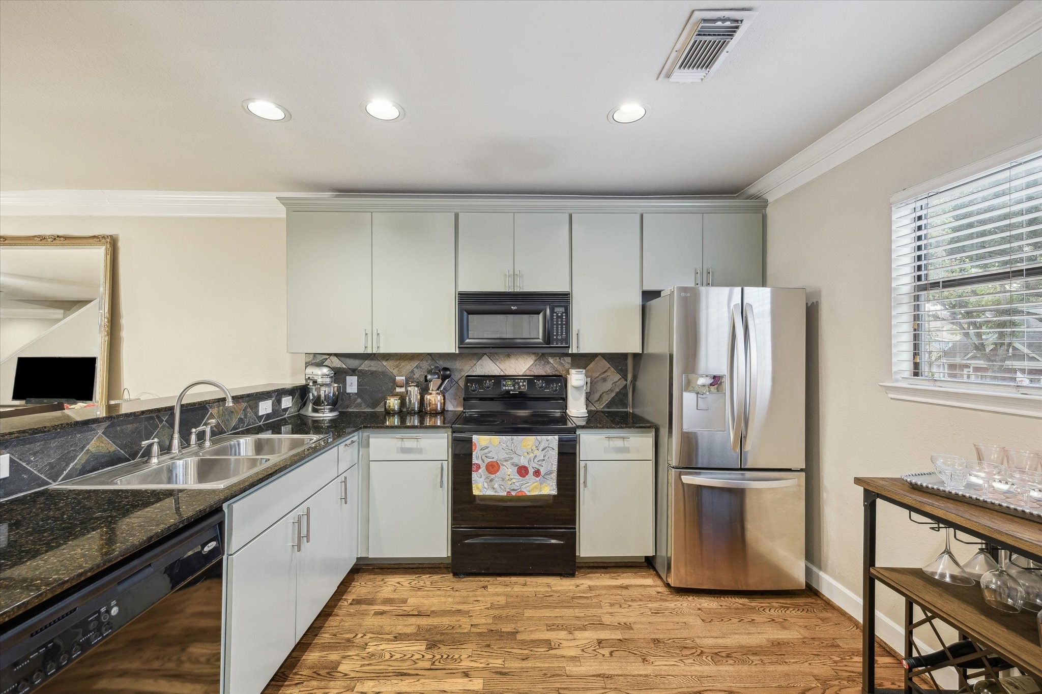 1342 Rutland Street, Unit 203 Houston, TX 77008 - Photo 11 of 20 a kitchen with granite countertop a refrigerator stove and sink