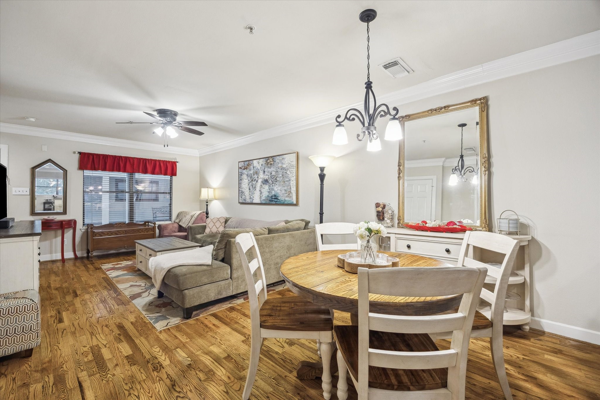 1342 Rutland Street, Unit 203 Houston, TX 77008 - Photo 7 of 20 a living room with furniture a chandelier and a table