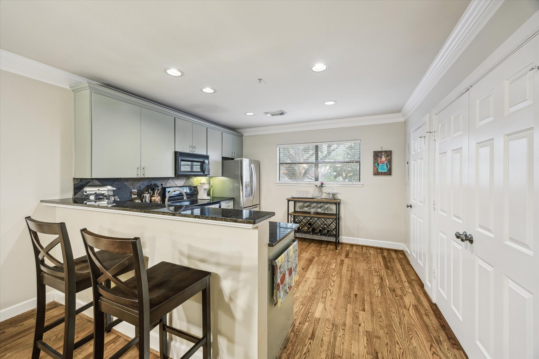 1342 Rutland Street, Unit 203 Houston, TX 77008 - Photo 9 of 20 a kitchen with a table and chairs in it