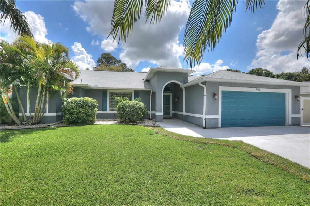 562 Rolling Hill Drive Sebastian, FL 32958 - Photo 1 of 42 a front view of a house with a yard and garage