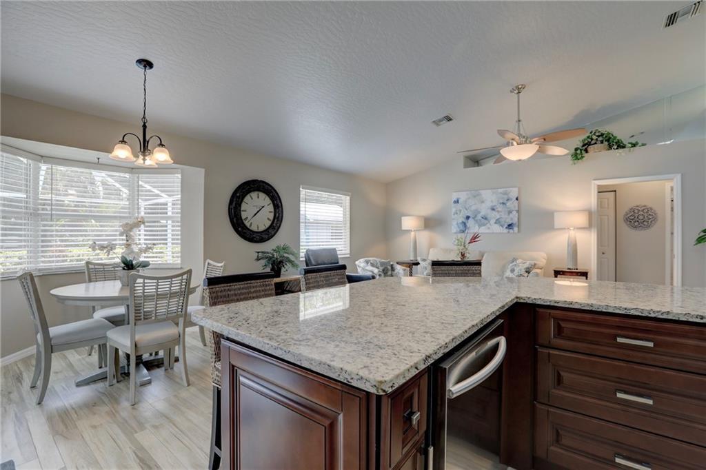562 Rolling Hill Drive Sebastian, FL 32958 - Photo 13 of 42 a kitchen with a table chairs and chandelier
