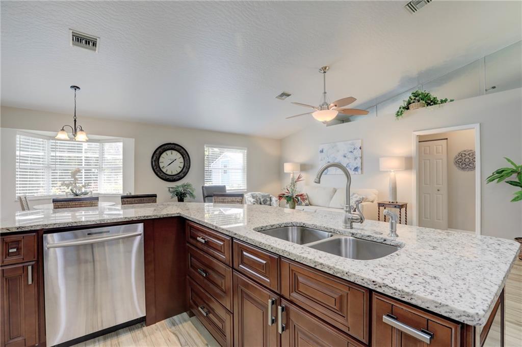562 Rolling Hill Drive Sebastian, FL 32958 - Photo 14 of 42 a kitchen with a sink and a clock on the wall