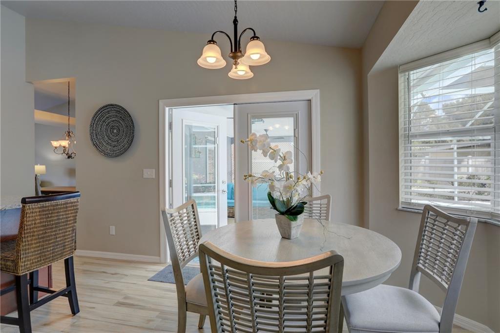 562 Rolling Hill Drive Sebastian, FL 32958 - Photo 18 of 42 a view of a dining room with furniture window and wooden floor