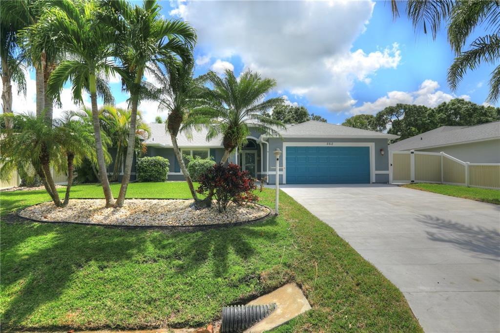 562 Rolling Hill Drive Sebastian, FL 32958 - Photo 2 of 42 a front view of a house with a yard and garage