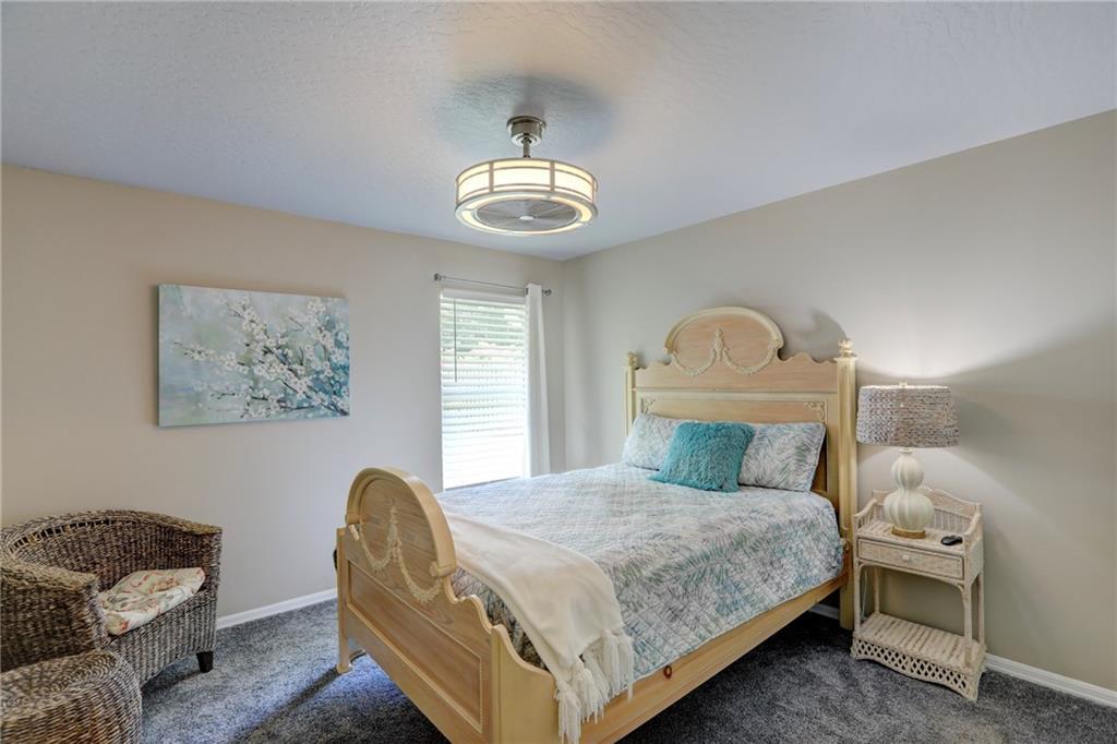 562 Rolling Hill Drive Sebastian, FL 32958 - Photo 23 of 42 a bedroom with a bed and a chandelier