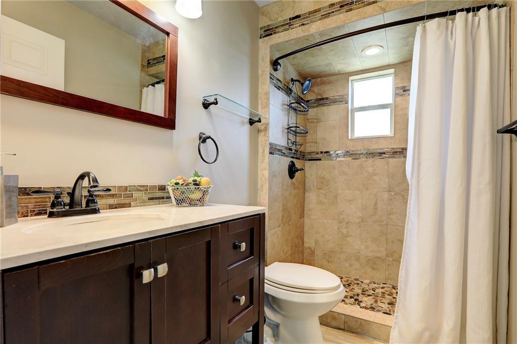 562 Rolling Hill Drive Sebastian, FL 32958 - Photo 24 of 42 a bathroom with a granite countertop sink toilet and shower