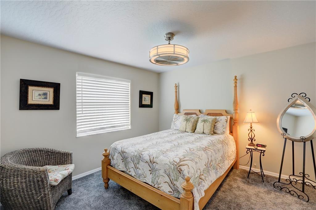 562 Rolling Hill Drive Sebastian, FL 32958 - Photo 25 of 42 a bedroom with a bed and a chandelier