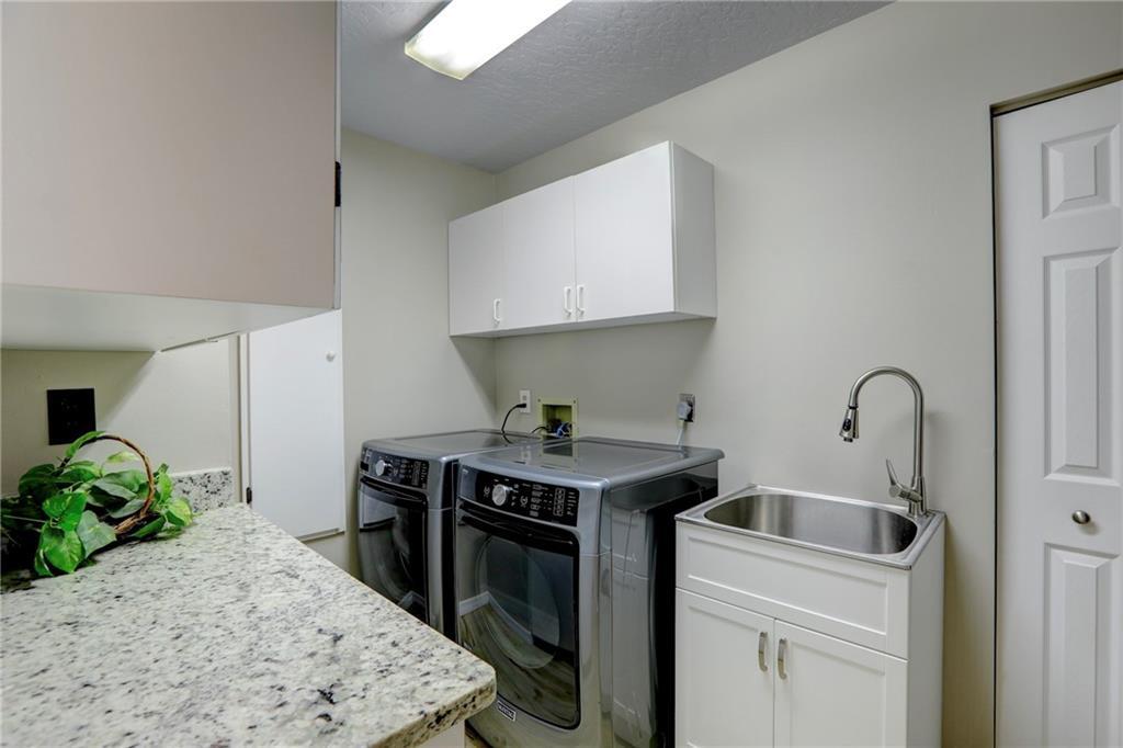562 Rolling Hill Drive Sebastian, FL 32958 - Photo 27 of 42 a kitchen with stainless steel appliances granite countertop a stove a sink and a refrigerator