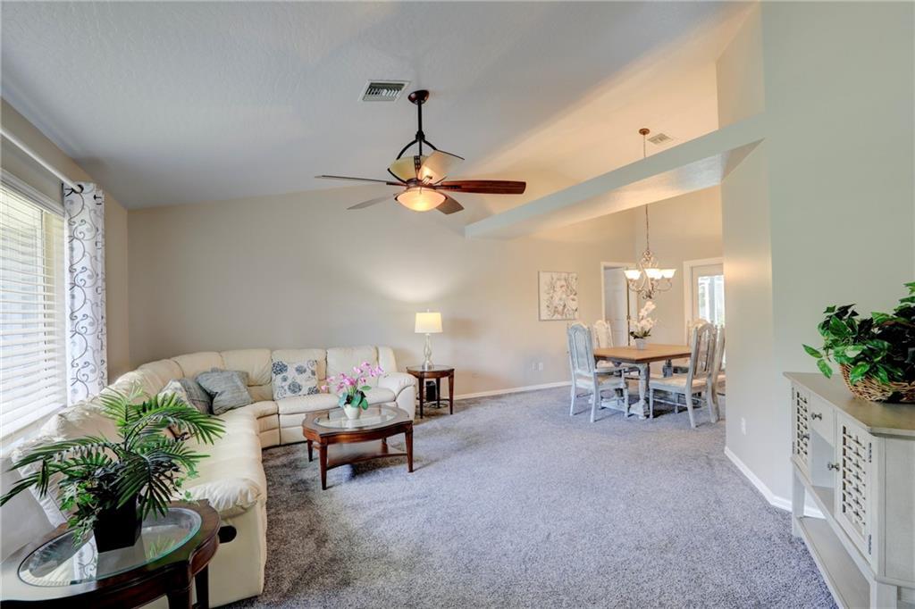 562 Rolling Hill Drive Sebastian, FL 32958 - Photo 6 of 42 a living room with furniture and a chandelier