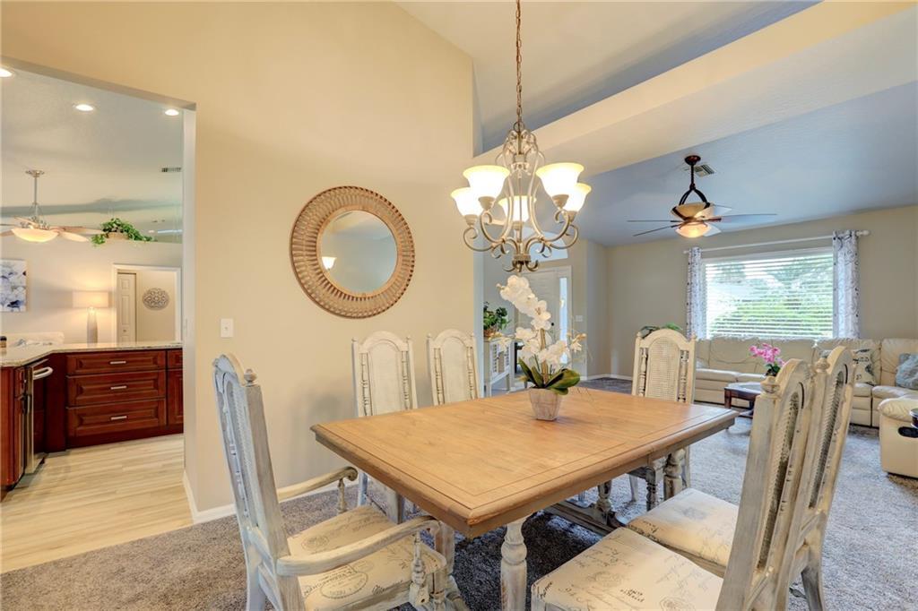 562 Rolling Hill Drive Sebastian, FL 32958 - Photo 8 of 42 a view of a dining room with furniture and chandelier