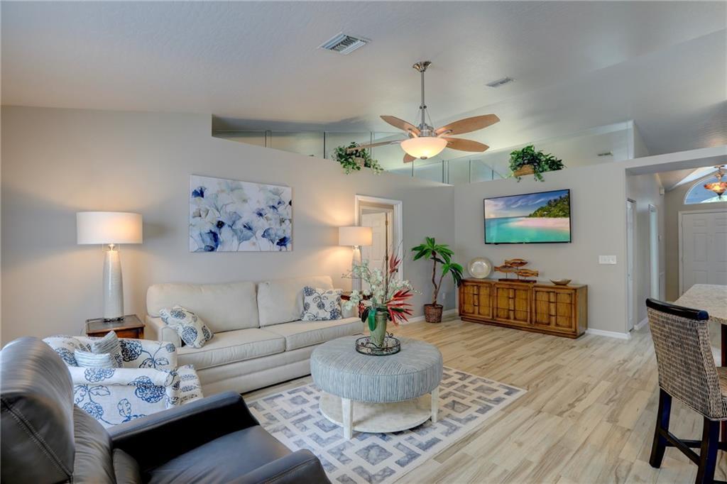 562 Rolling Hill Drive Sebastian, FL 32958 - Photo 9 of 42 a living room with furniture and a chandelier