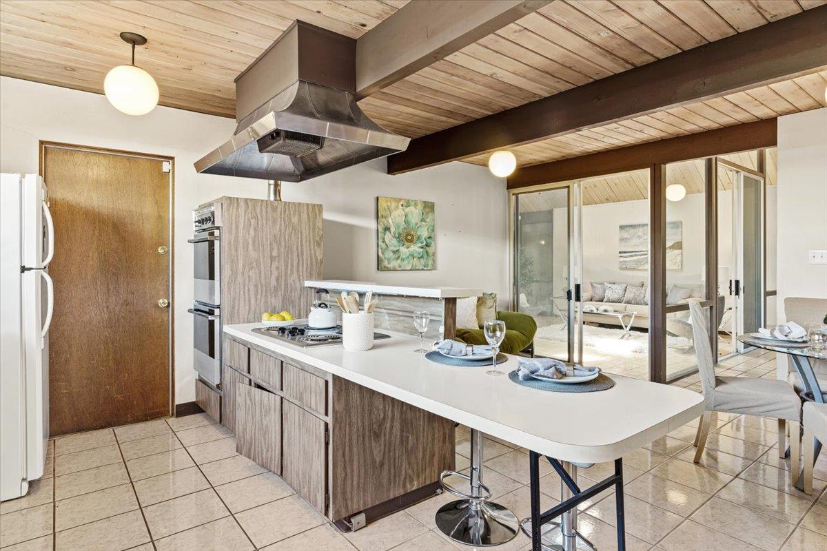1103 East Homestead Road Sunnyvale, CA 94087 - Photo 11 of 29 a kitchen with a table chairs stove and refrigerator