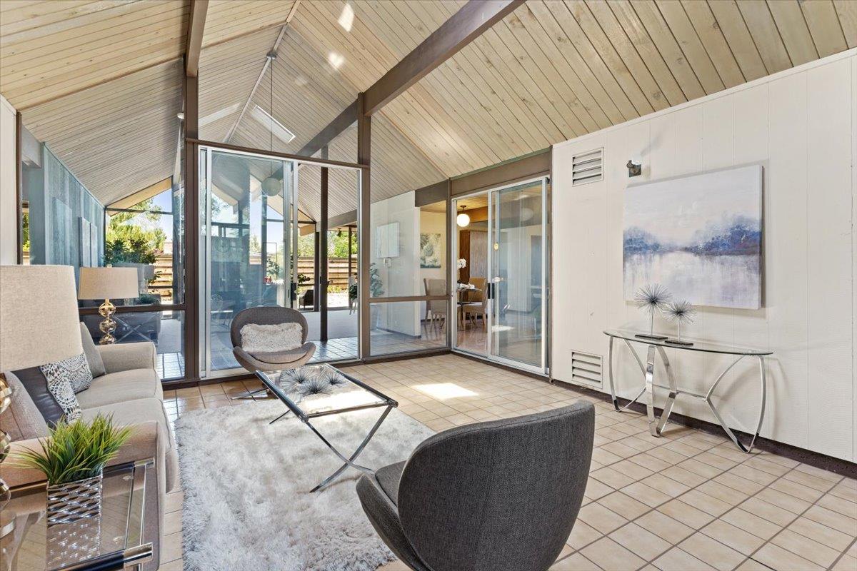 1103 East Homestead Road Sunnyvale, CA 94087 - Photo 8 of 29 a living room with furniture a flat screen tv and next to a window