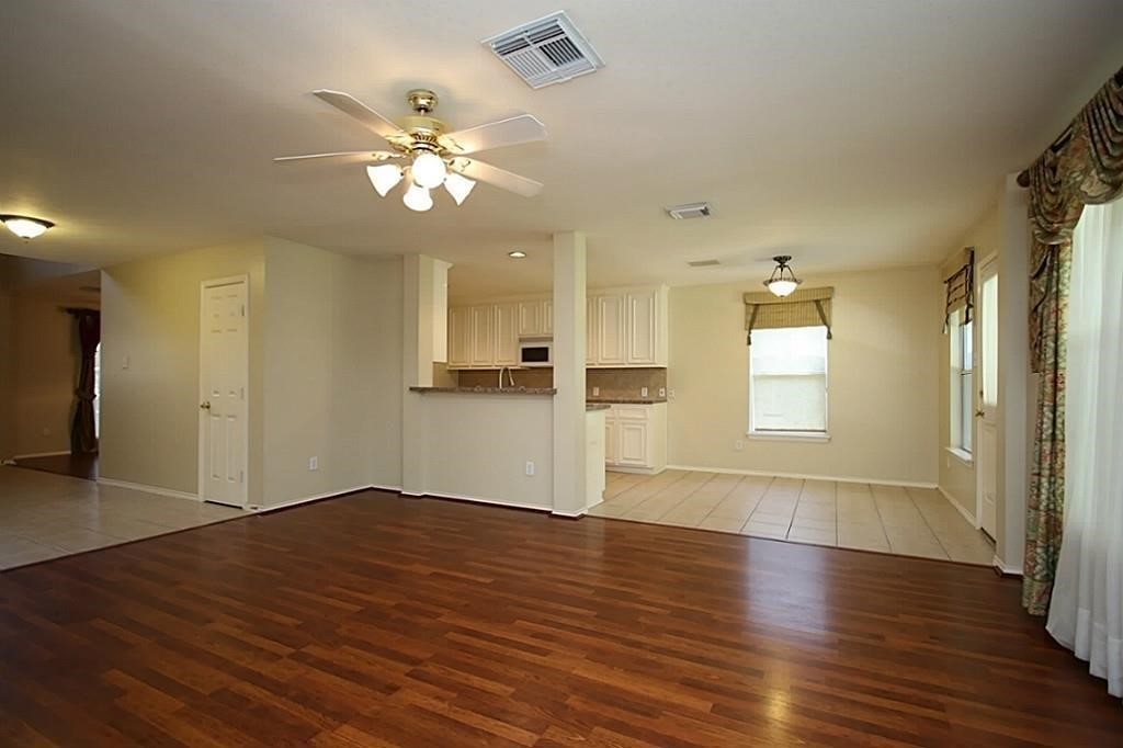 28511 Cory Terrace Court Spring, TX 77386 - Photo 11 of 31 a view of an empty room with wooden floor and a window