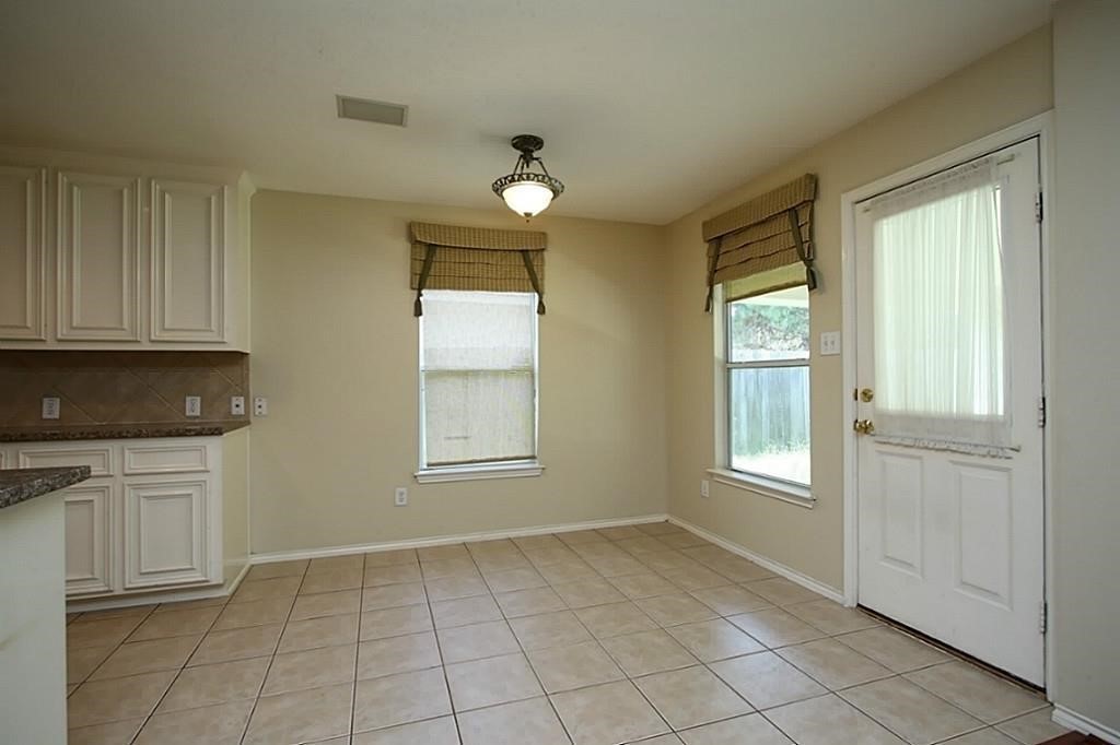 28511 Cory Terrace Court Spring, TX 77386 - Photo 13 of 31 an empty room with windows and cabinet