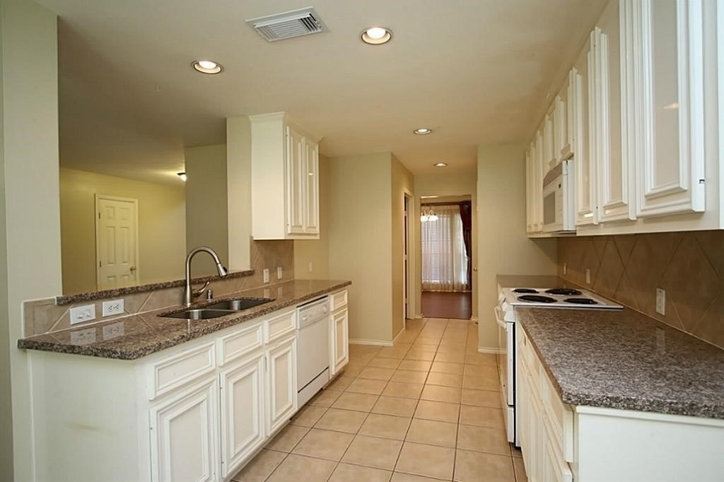 28511 Cory Terrace Court Spring, TX 77386 - Photo 15 of 31 a kitchen with granite countertop a sink and cabinets