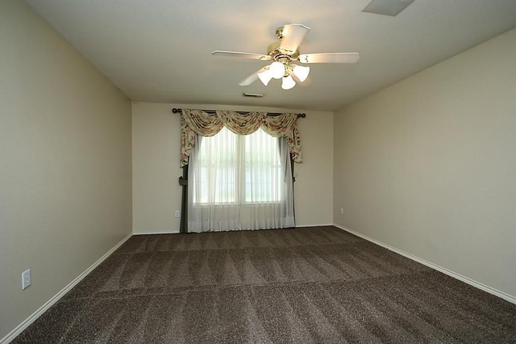 28511 Cory Terrace Court Spring, TX 77386 - Photo 17 of 31 an empty room with wooden floor and windows