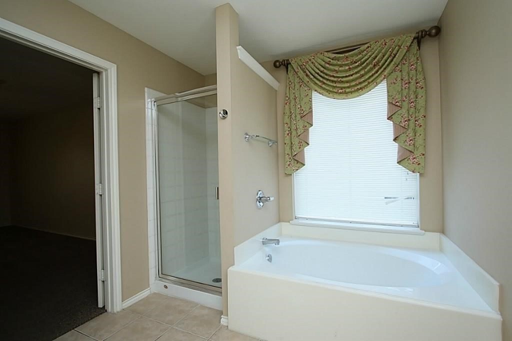 28511 Cory Terrace Court Spring, TX 77386 - Photo 20 of 31 a bathroom with a bathtub and a shower