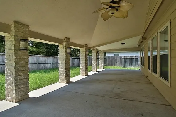 a view of a house with backyard and porch