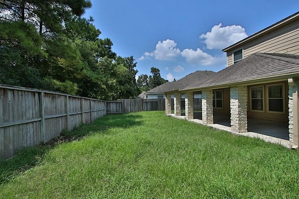 28511 Cory Terrace Court Spring, TX 77386 - Photo 30 of 31 a view of a house with backyard and porch