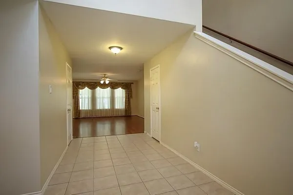 a view of a room with wooden floor and staircase