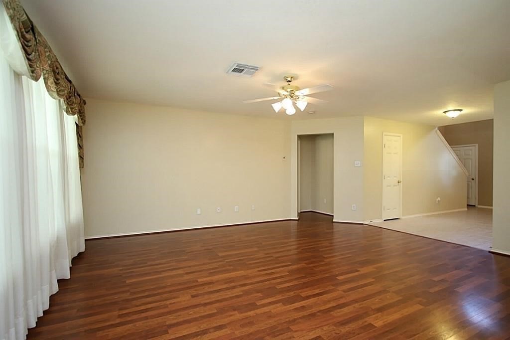 28511 Cory Terrace Court Spring, TX 77386 - Photo 10 of 31 a view of an empty room with wooden floor and a window