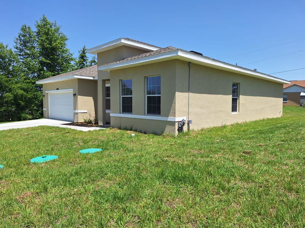 4655 Southwest 139th Lane Ocala, FL 34473 - Photo 2 of 15 a view of a house with a yard
