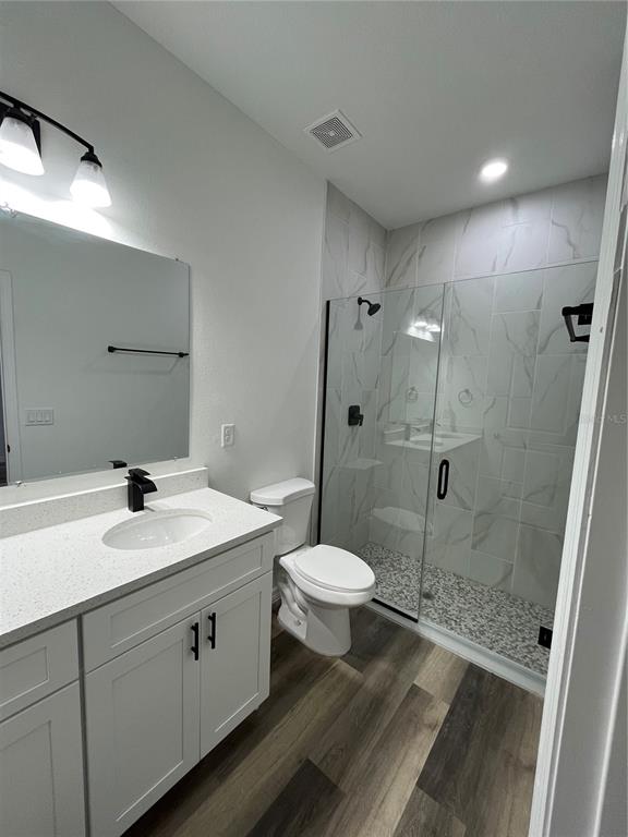 4655 Southwest 139th Lane Ocala, FL 34473 - Photo 10 of 15 a bathroom with a sink a toilet and shower