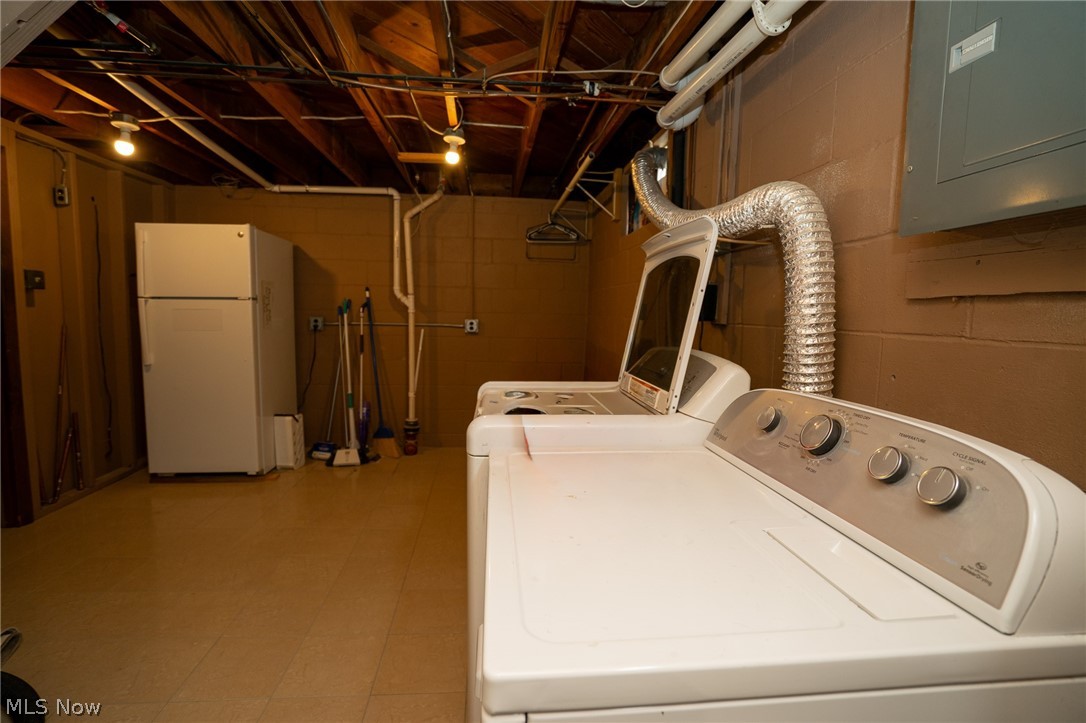 453 Omar Street Struthers, OH 44471 - Photo 27 of 27 Laundry area with electric panel, washer and dryer, and light flooring