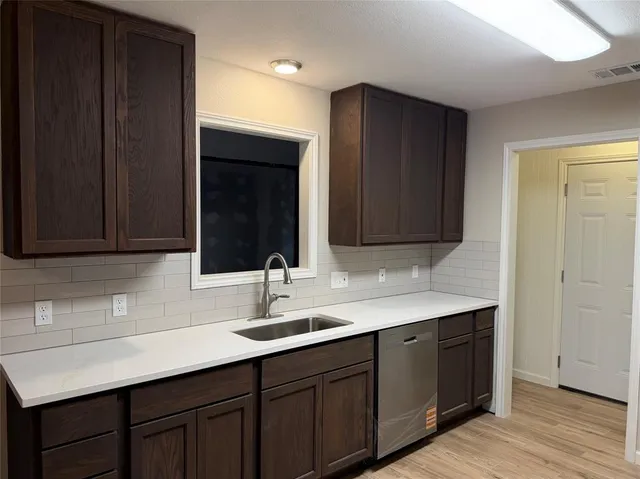 a bathroom with a double vanity sink and large mirror