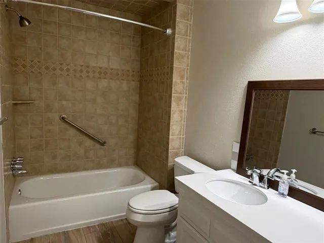 a bathroom with a sink a toilet and a bathtub
