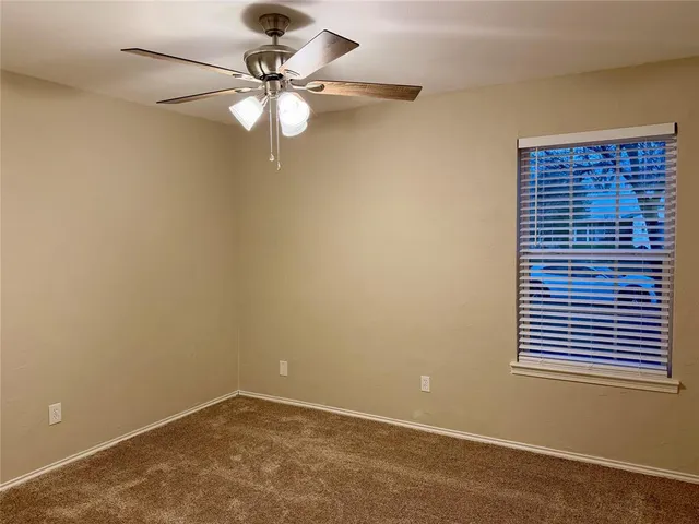 a view of a workspace with a chandelier fan