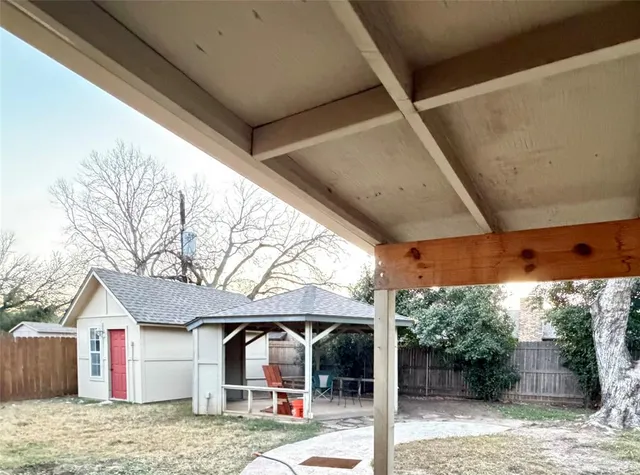 a backyard of a house with garden and outdoor seating