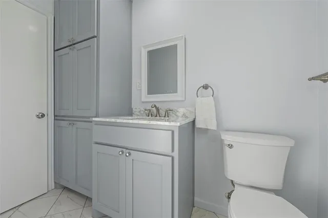 a bathroom with a sink toilet and mirror