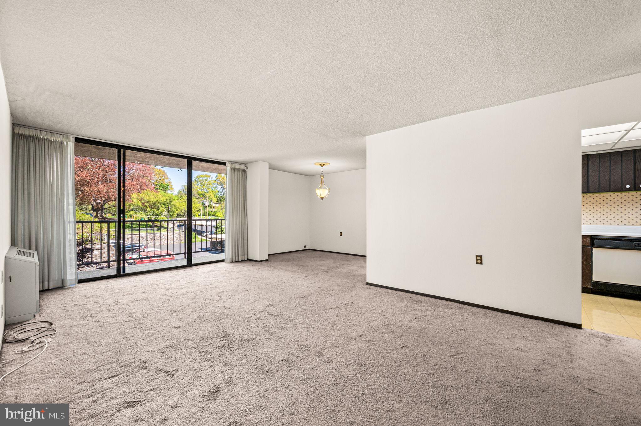 801 Yale Avenue, Unit 511 Swarthmore, PA 19081 - Photo 3 of 28 Living room and dining area with balcony views.