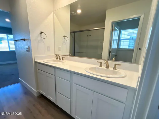 a bathroom with a double vanity sink and a mirror