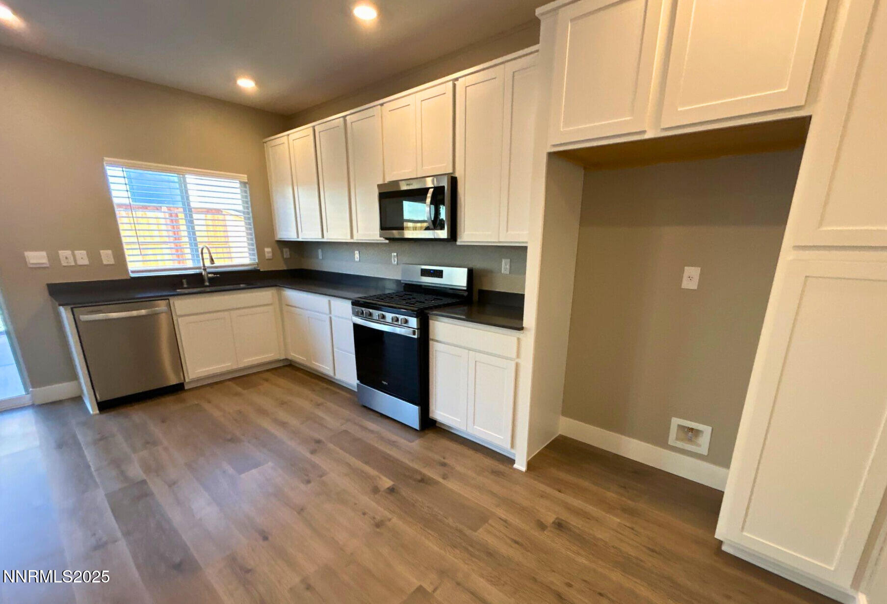 7976 Corundum Drive Sparks, NV 89436 - Photo 3 of 19 a kitchen with stainless steel appliances granite countertop a stove a sink and a refrigerator