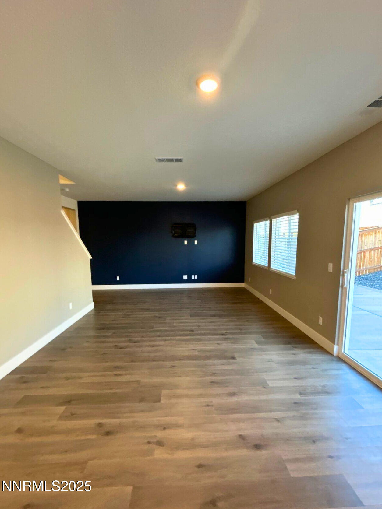 7976 Corundum Drive Sparks, NV 89436 - Photo 6 of 19 a view of an empty room with window and wooden floor