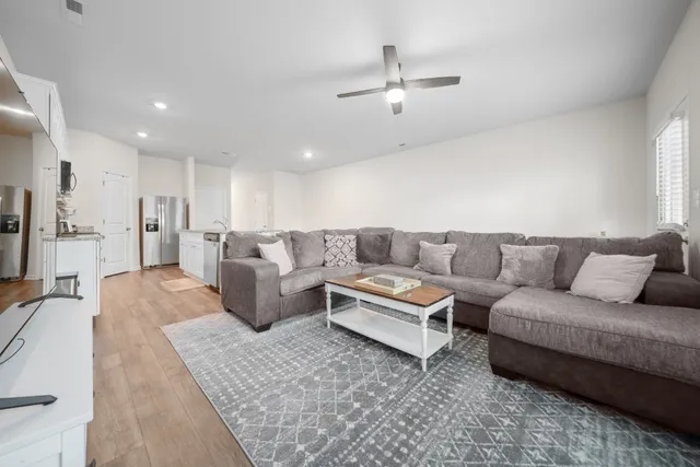 a living room with furniture and kitchen view