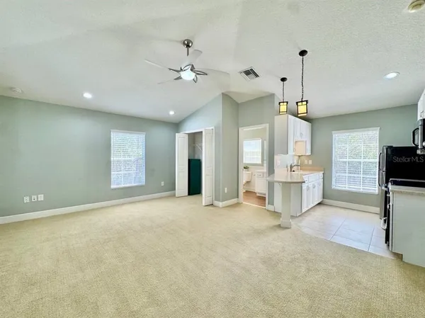 a view of a livingroom with a kitchen