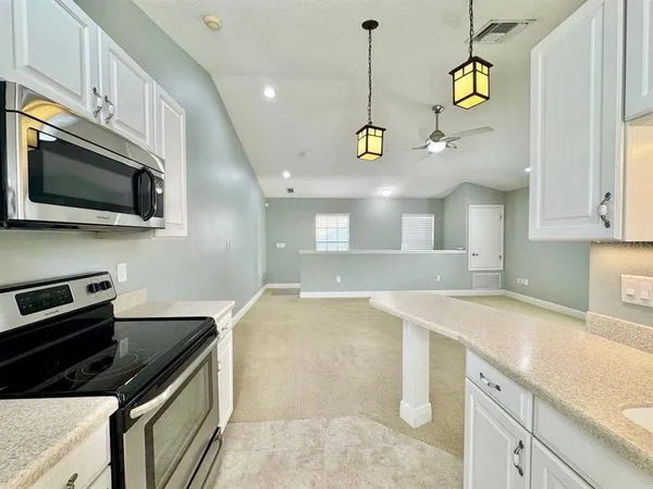 a kitchen with a sink stainless steel appliances and cabinets