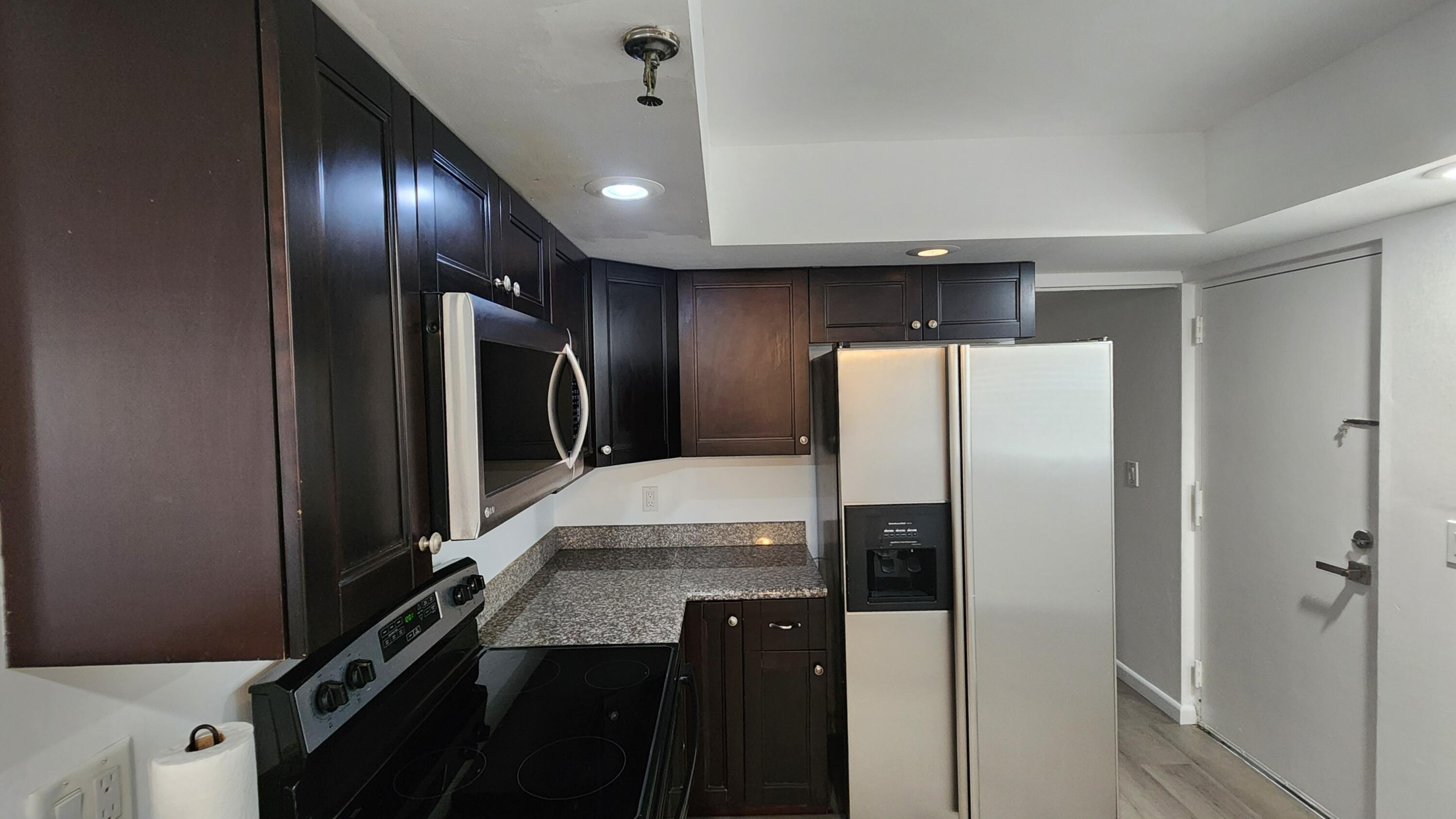 6500 Northwest 2nd Avenue, Unit 311 Boca Raton, FL 33487 - Photo 18 of 43 Beautiful dark wood cabinets