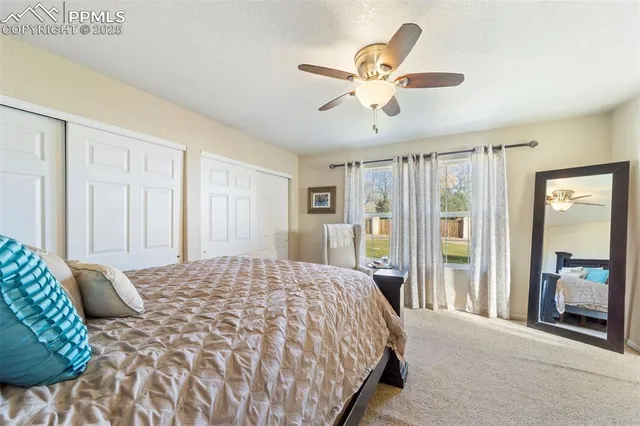 a bedroom with a large bed and a chandelier